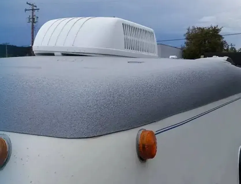 Sprayed RV roof edge and front cap